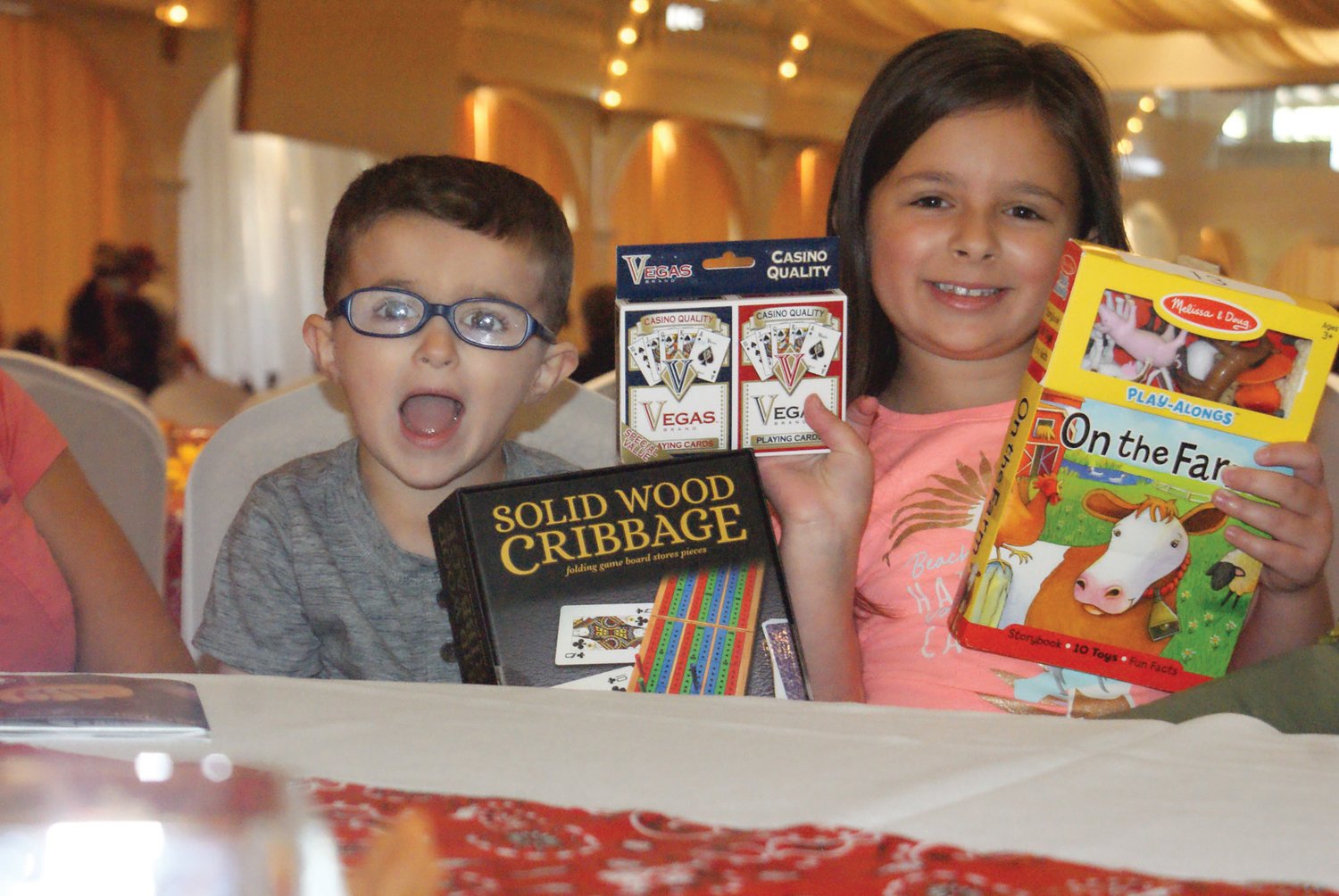 HAPPY WINNERS: The smiles say it all as the Volino siblings, Teddy, 4, and Sophia, 6, show off their winnings after the penny social.